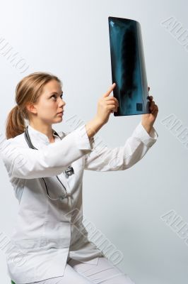 young blonde doctor with x-ray picture staring