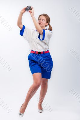 young pretty blonde female sailor with camera