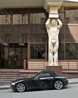 Modern car and a giant Modern car and a giant
