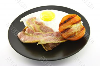 Bacon, Eggs and Tomato on a Black Plate