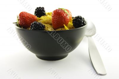 Cornflakes and Fruit in a Black Bowl with a Spoon