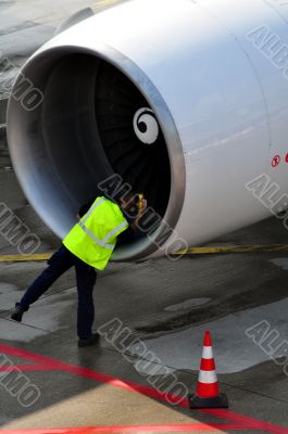 Engineer inspecting aircraft engine