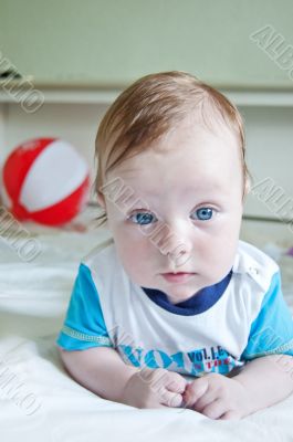 Cute baby boy lying on his belly