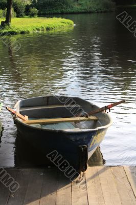 wooden boat at moorage on a lake