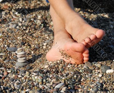 Rocks stack and boy feet Rocks stack and boy feet