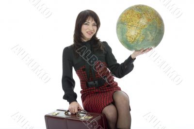 Beautiful brunette with valise and globe