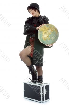 Beautiful brunette with valise and globe
