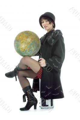Beautiful brunette with valise and globe