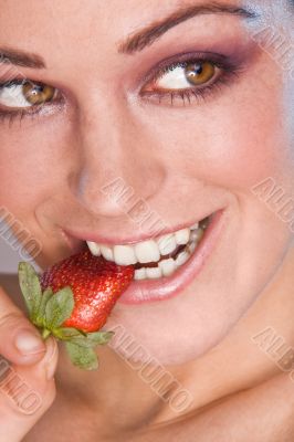 Image of beautiful girl holding strawberry