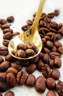 Coffee beans and golden spoon Coffee beans and golden spoon