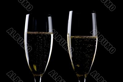 Two glasses champagne on black macro