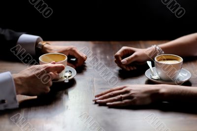 Bride`s and groom`s hands holding coffee cups Bride`s and groom`s hands holding coffee cups