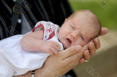 Newborn baby in father`s arms