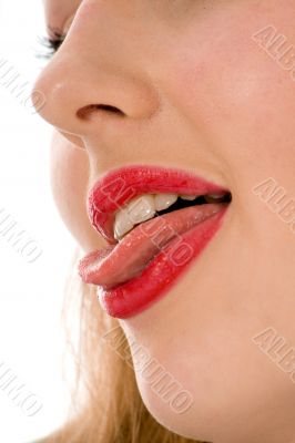 Beautiful woman leaking teeth with tongue close-up