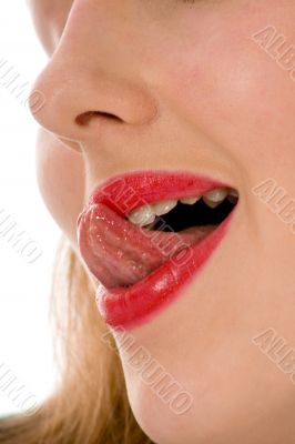 Beautiful woman leaking teeth with tongue close-up