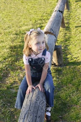 Small Girl Sitting on Log