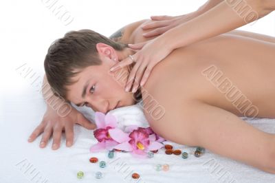 Attractive man getting spa treatment on white