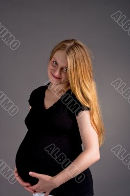 smiling young pregnant blonde in dark shirt