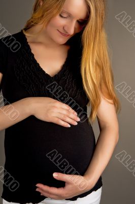 dreaming young pregnant blonde isolated