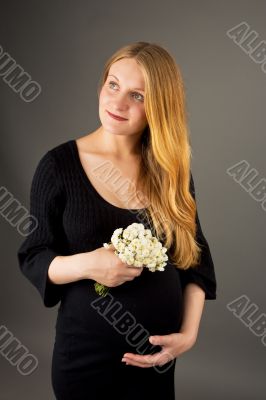 smiling gentle young pregnant blonde woman