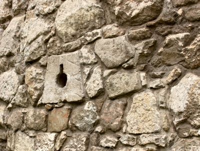 Ancient stone wall with loopholes