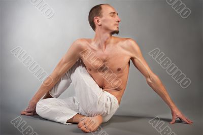 Handsome young man in yoga position