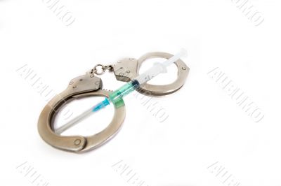 Handcuffs and syringe