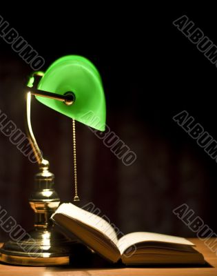 Electric green table lamp and book