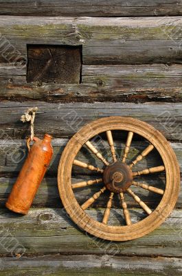 Ceramic Bottle And Spinning Wheel On The Wall