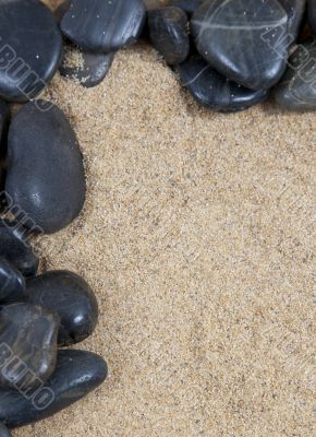 zen spa river rocks on sand in form of border