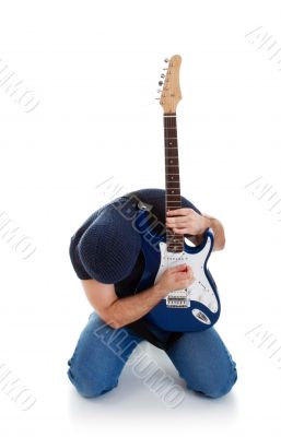 rocker playing guitar kneeling