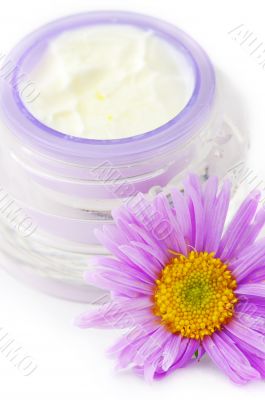 Closeup of open container of cosmetic face cream on white backro