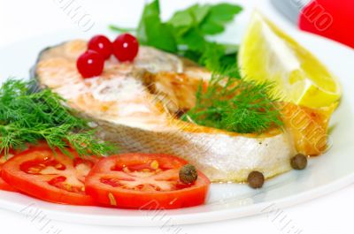 grilled fish with vegetables and slice of lemon