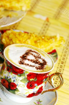 Cappuchino, with chocolate heart and cake 