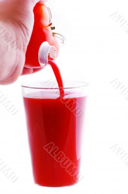 pouring fresh tomato juice on a white background
