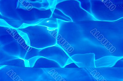 Blue water background with sunlight 