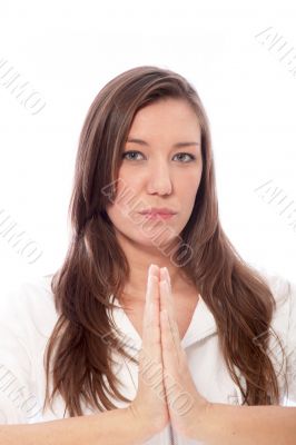 Woman with folded hands, looking into the camera. 