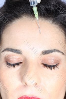 Young woman receives botox injection 