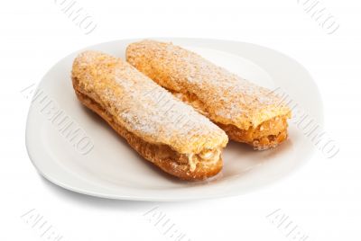 two tasty eclairs on dish two tasty eclairs on dish