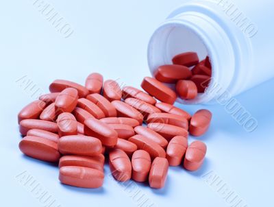 red pills spill out from bottle red pills spill out from bottle