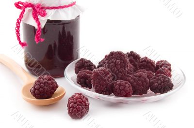 Blackberry jam in bowl and berries