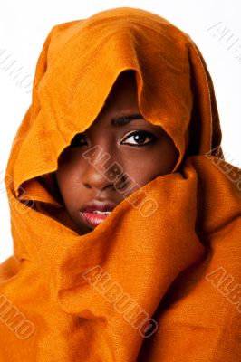 Mysterious female face in ocher head wrap