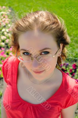 The woman looking atop of glasses