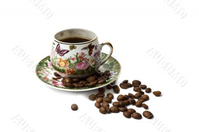 Coffee cup with scattering of coffee beans. Isolated on a white 