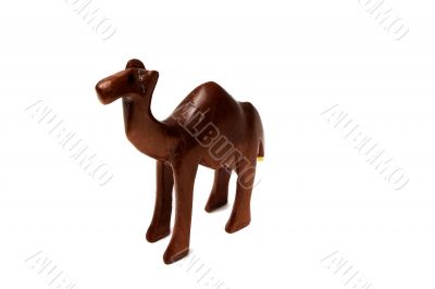 Souvenir figure of a wooden camel. Isolated on white background.