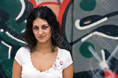 The beautiful girl against graffiti. 