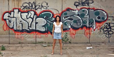 The beautiful girl against graffiti. 