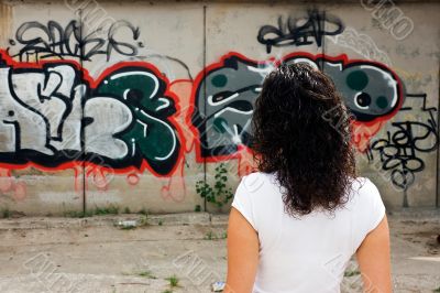 The beautiful girl against graffiti. 