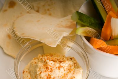 hummus dip with pita bread and vegetable