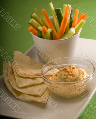 hummus dip with pita bread and vegetable